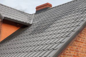 The closed view of attractive metal roof with red brick house at Fort Lauderdale, FL