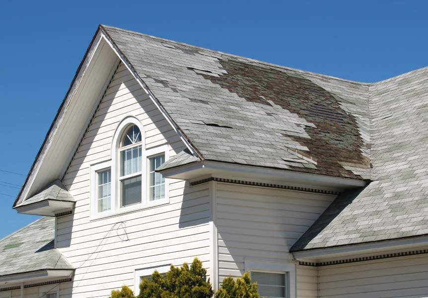 Residence featuring a roof that has sustained significant damage in South Florida
