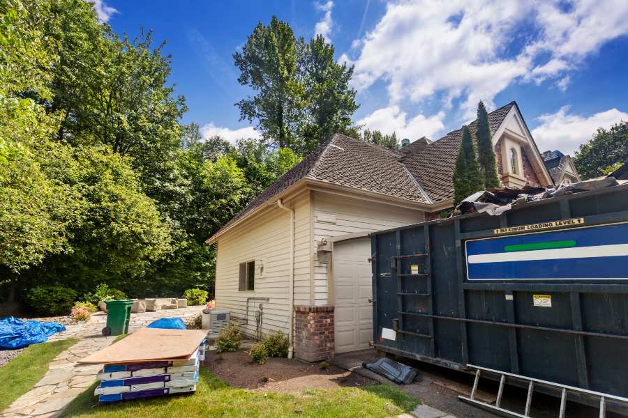 A house featuring a dumpster in the yard in South Florida
